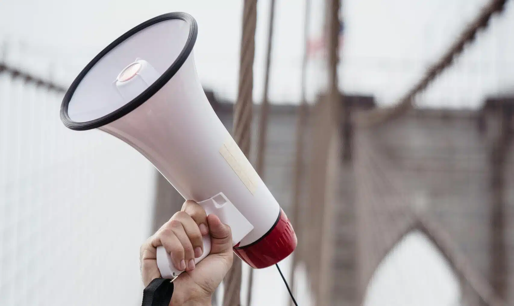 Photo of hand holding up a megaphone